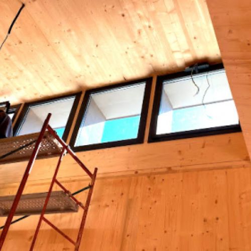 Ventanas en zona superior de interior de edificio en madera